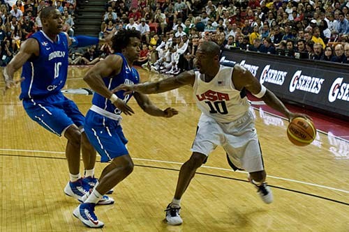 Close up photo of professional basketball player Kobe Bryant dribbling a basketball during a game