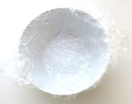 A bowl lined with two layers of plastic wrap