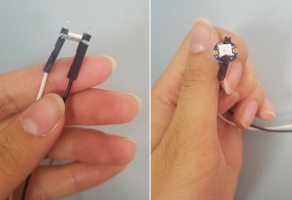 Jumper wires are capped by black plastic pieces from male header pins.  Birds-eye-view of capped jumper wires. 