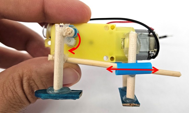 Side view of the slider crank mechanism with arrows showing the directions of motion 