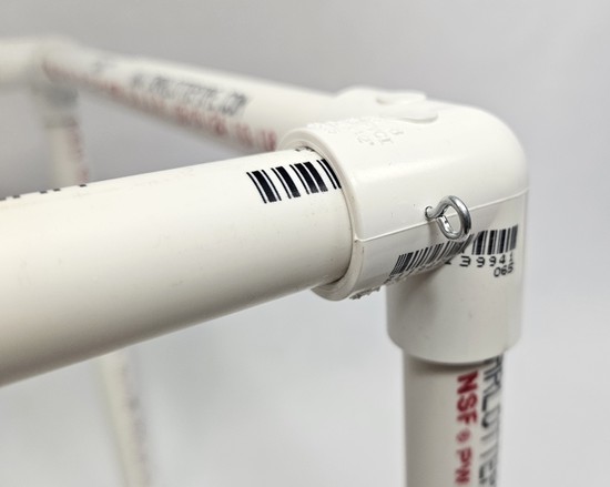 Close-up of a screw eye screwed into the PVC frame
