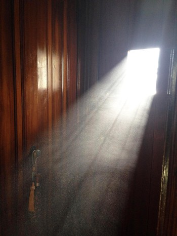 Dust being shined on by sunlight through a window. 