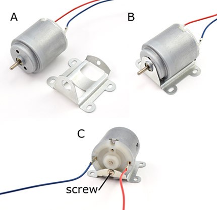 A small motor is attached to a metal bracket with a screw