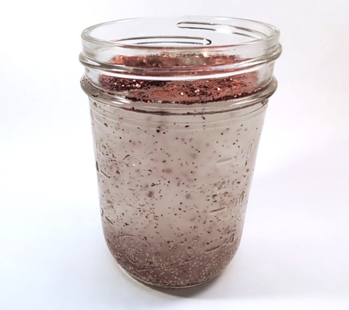 Jar of glitter, yeast, and water.
