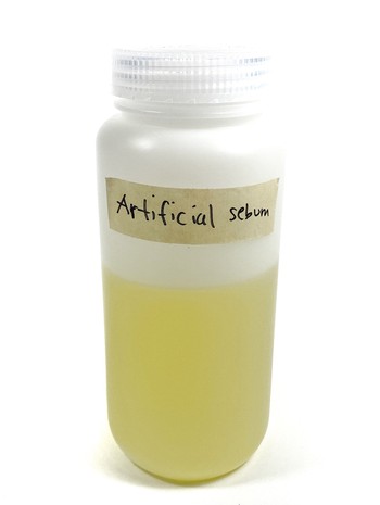 A bottle filled with a yellow liquid.