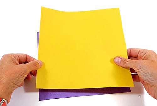 Two paper squares lying on top of each other.