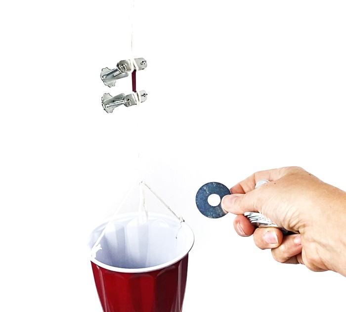 A tensile strength test using a weighted container. 
