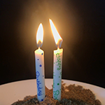 Two candles side by side for a science activity in which the flame jumps between them