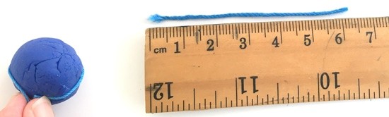 Illustration showing a string wrapped around a sphere with a diameter of 2 cm. The string is a little over 6 cm long.