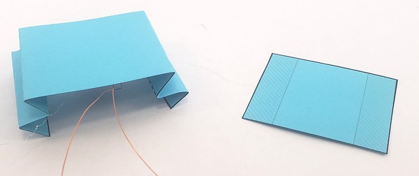 Accordion piece turned upside-down and next to rectangle base template piece. 