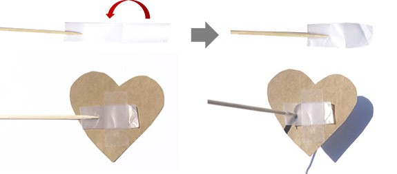 The tip of a wooden skewer lies on a piece of tape (top left). A piece of tape is folded over the tip of a skewer (top right). A heart cutout is taped to a wooden skewer (bottom)
