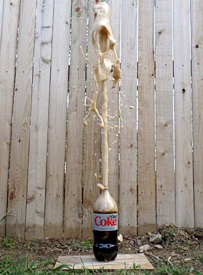 Foam erupting from a bottle of diet coke