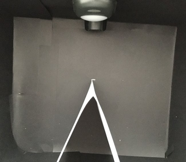  Top view of the opened-up test box. The V shape stands in the box with point of the V facing the light.   