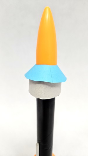 A model rocket nose cone with a modified shape to adapt to a ring fin