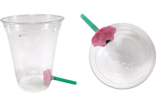 Straws are inserted into holes cut near the bottom of two plastic cups and are sealed with modeling clay