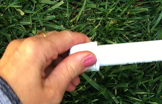 A cap being pushed onto a PVC pipe