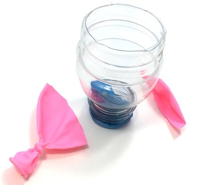 Cut bottle placed on its small opening and a knotted balloon where the top 1/3 is cut off.
