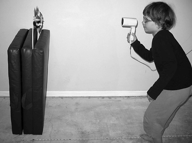 A blow-dryer being blown at a pinwheel
