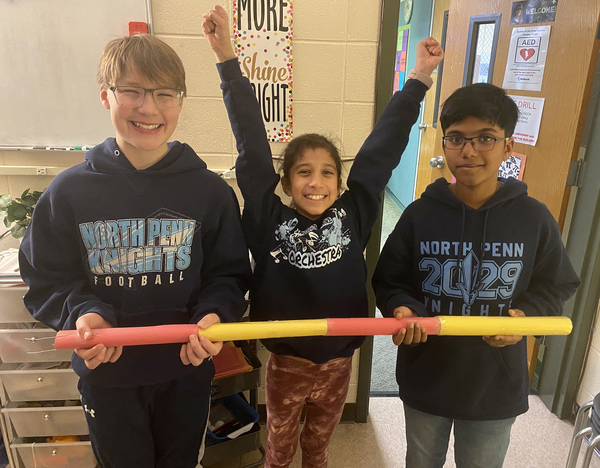 Three students who entered the Ping Pong Pickup Challenge with the device they entered
