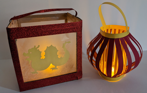 Two homemade lanterns, one square and one with with vertical slats, from student lantern building activity