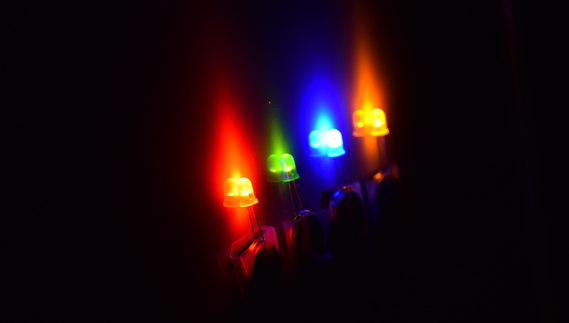 Four lit LED stickies or throwies in a row