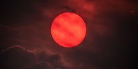 APOD: 2026 July 30 – Red Sun trough Wildfire Smoke