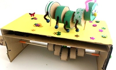 A side view of a caterpillar cardboard automaton.