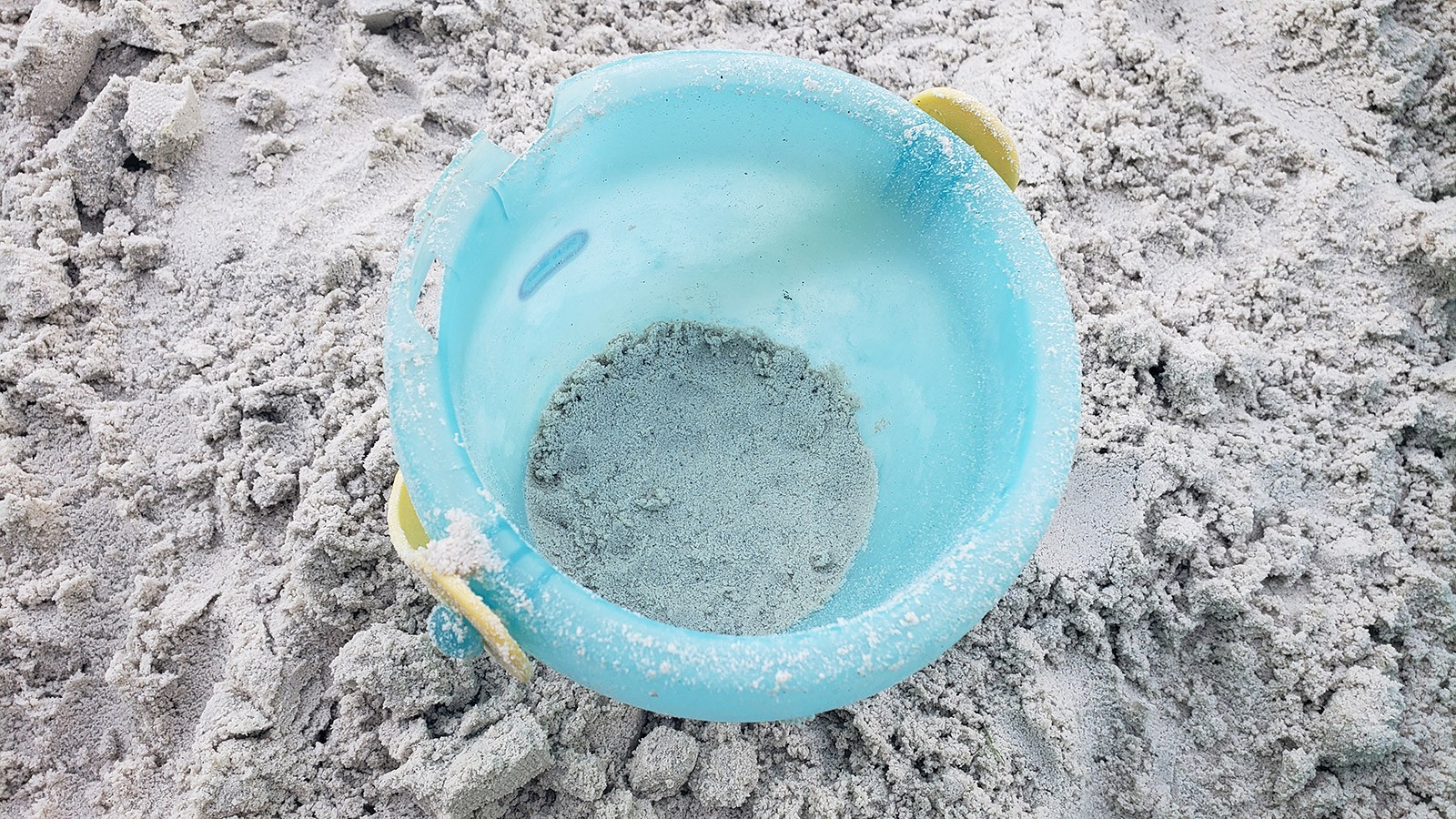 A bucket with another layer of sand added.