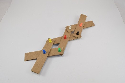 Strips of cardboard pinned together with push pins
