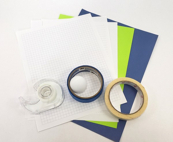 different types of paper, tape, and a ping pong ball for materials