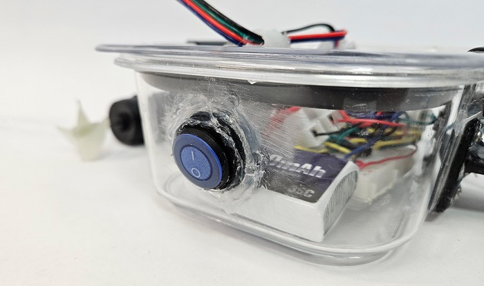 An on/off rocker switch mounted through the back of the ROV case, with silicone sealant around the edge 