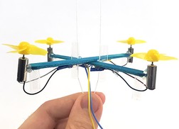 drone mounted on two strings which are pulled taut at the bottom
