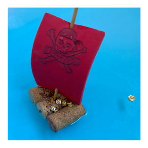 A pirate-themed sailboat made from corks - Pirate-themed Make-Believe STEM Science Experiments