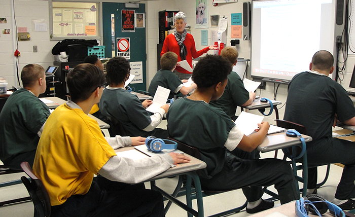 A teacher presenting in front of a class of students