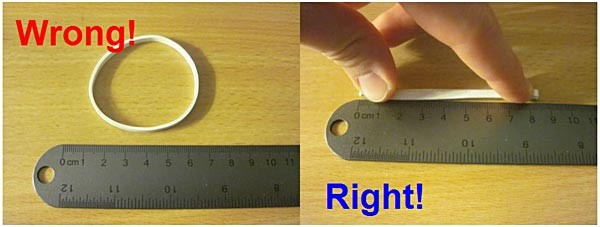 Photos show a rubber band needs to be pressed flat against a table to be measured accurately