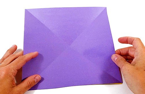 Paper square with two diagonal creases.