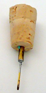 Needle stuck into a cork