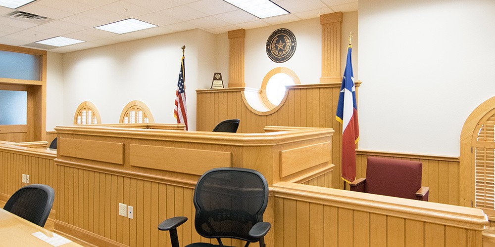 the judge's desk and witness stand of a courtroom 