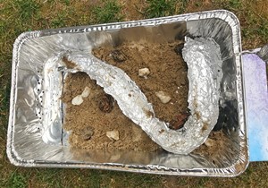 Aluminum pan with an aluminum foil river inside with water flowing through it.