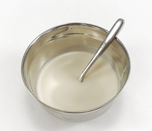 A bowl with a coconut milk shampoo mixture inside.