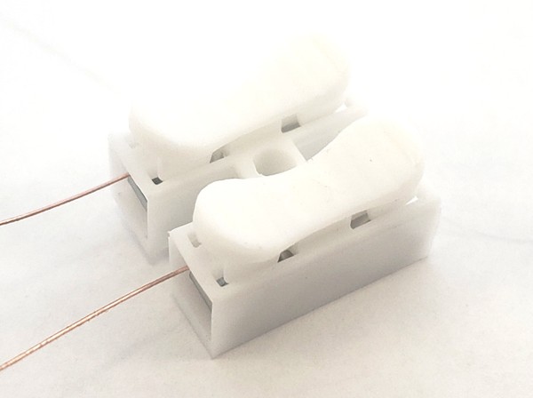 Magnet wire inserted into spring clips 