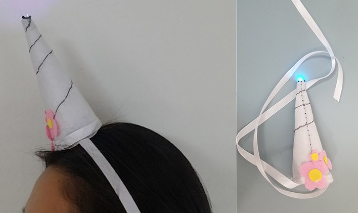 Finished unicorn horn on head with LED on.