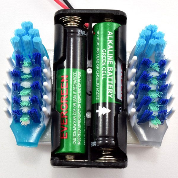 Attach the two toothbrush heads 