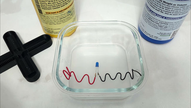 LED with wire springs embedded in silicone