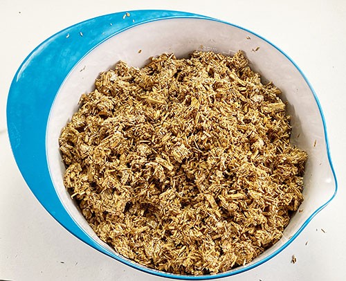 Organic material that looks like small wood chips in a bowl.