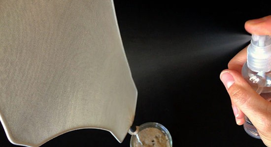 Water is sprayed from a spray bottle onto a self-made fog catcher.