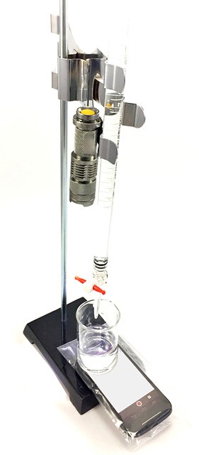A smartphone in a plastic bag is placed beneath a beaker that has a buret suspended above it