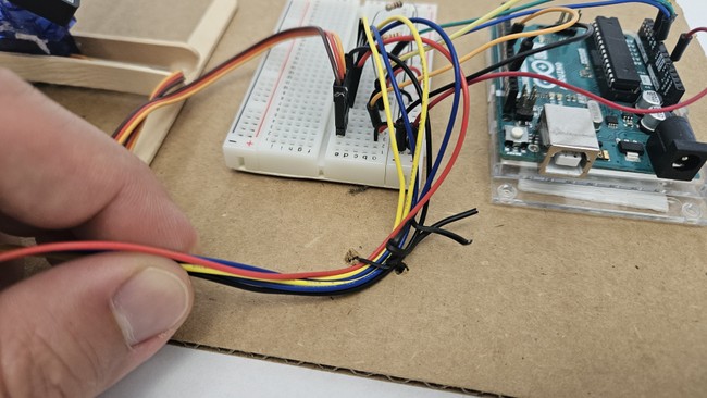 Wires connected to cardboard with a twist tie