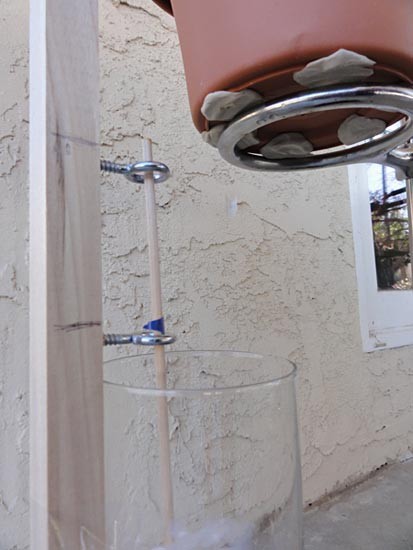 Water dripping from a pot into a beaker underneath