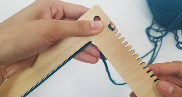 Loom's warp being threaded. 